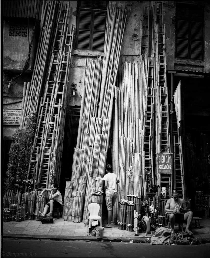 Bamboo stall owners with their 5 meter bamboo on display along the pavement of Hanoi City.
